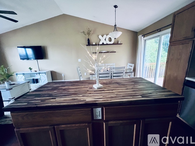 A dining room with a wooden table and chairs.