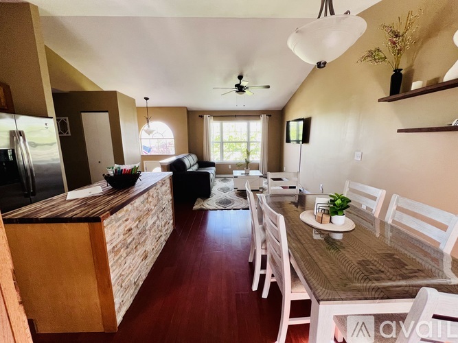 A kitchen with a dining table and chairs.