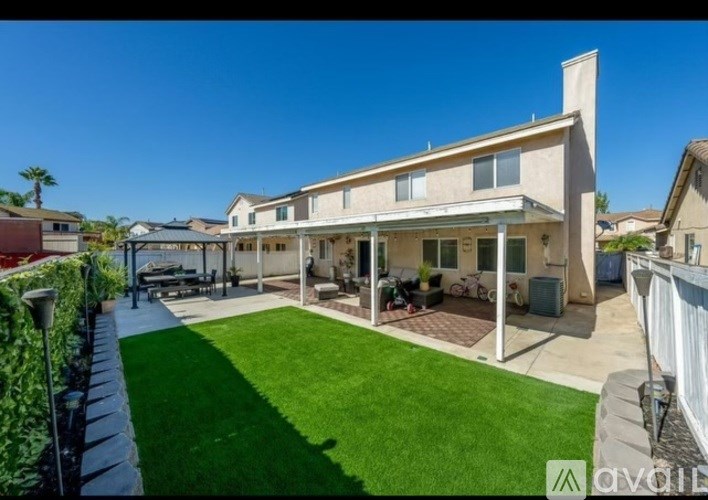 A house with a green lawn in front.