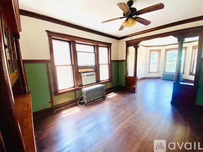 A room with a fan and a window.