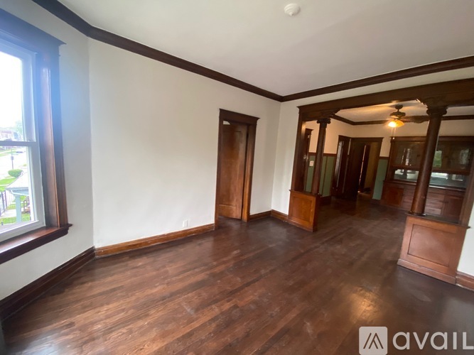 A room with wooden floors and a ceiling fan.