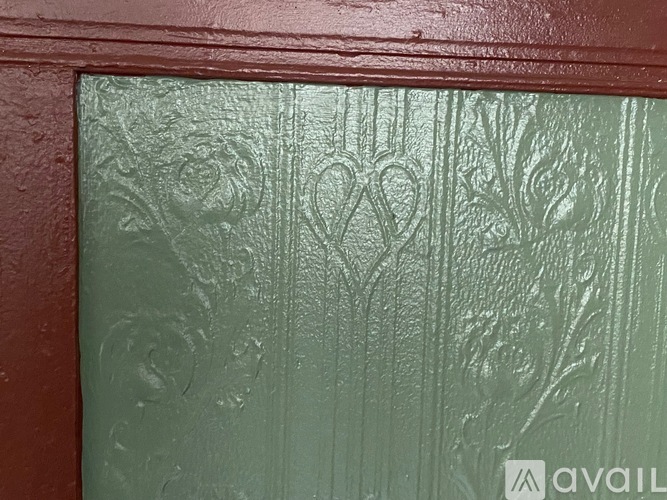 A close up of a textured surface with a pattern of hearts and trees.
