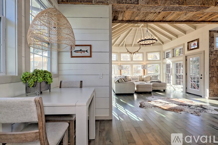 A modern interior with a dining area and a living room.