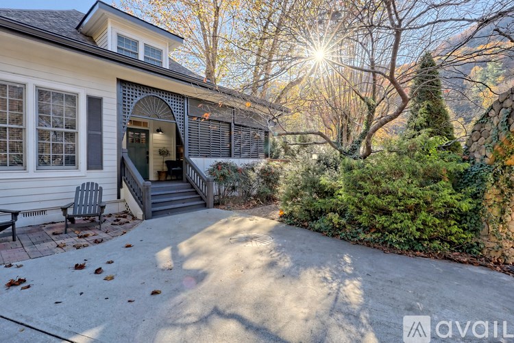 A house with a patio and a tree in front of it.