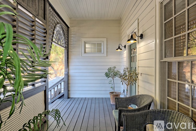 A small balcony with a table and chairs.