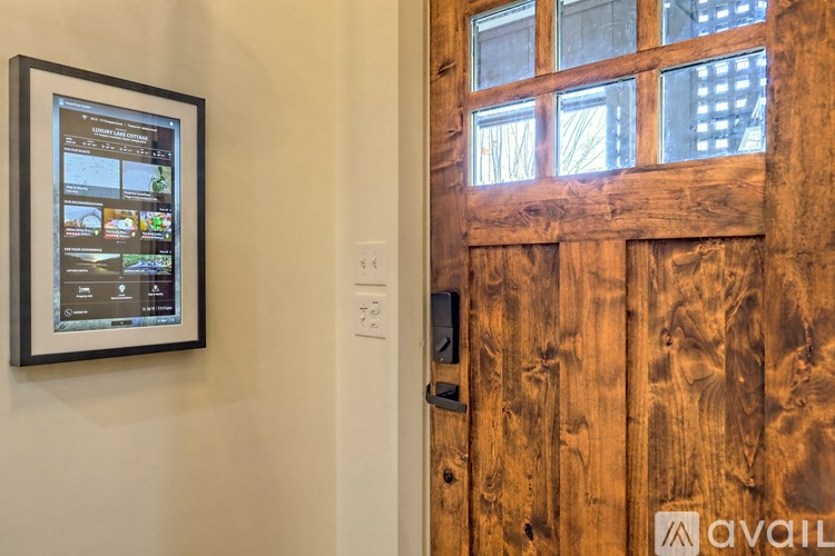 A wooden door with a digital screen on the wall.