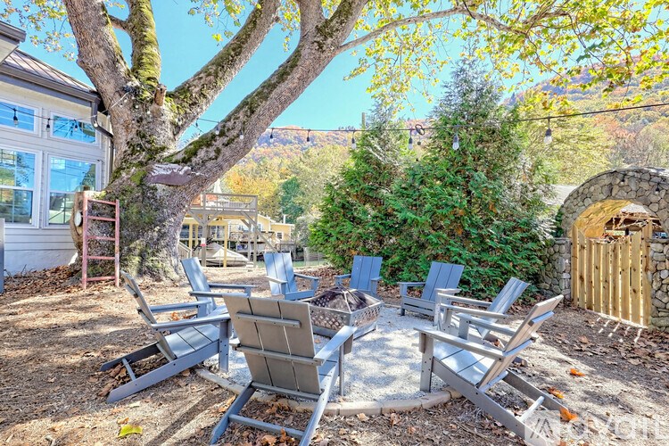 A set of four chairs and a table are arranged in a circle on a patio.