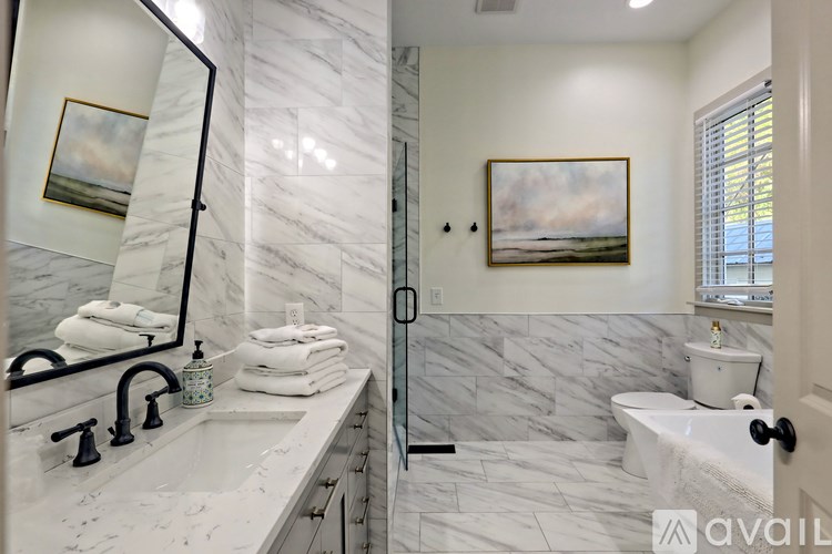 A bathroom with a marble sink and toilet.