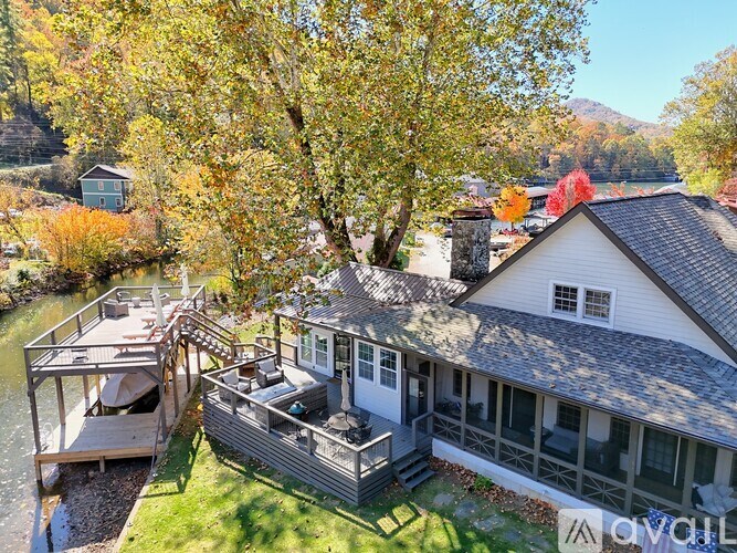 A house with a deck overlooking a river.