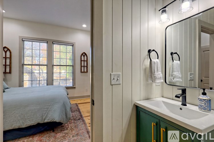 A bathroom with a blue bed in the corner.