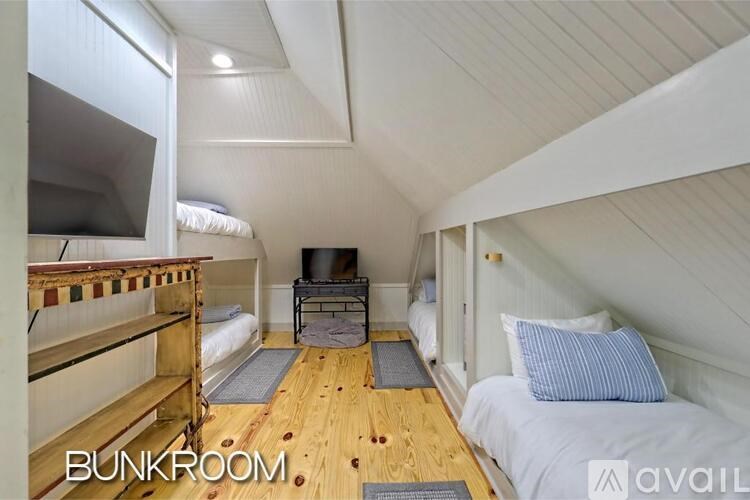 A bunk room with a bed, a mattress, and a bedside table.