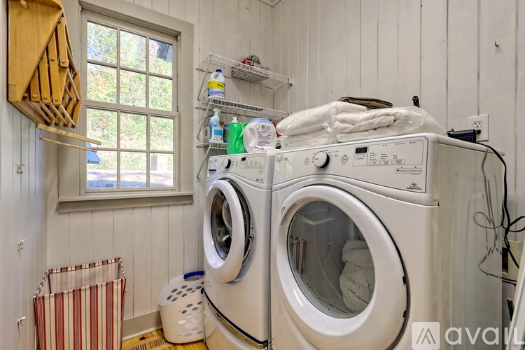 A white washing machine and dryer in a small laundry room.
