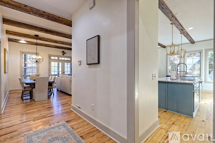A living room with a dining table and chairs.
