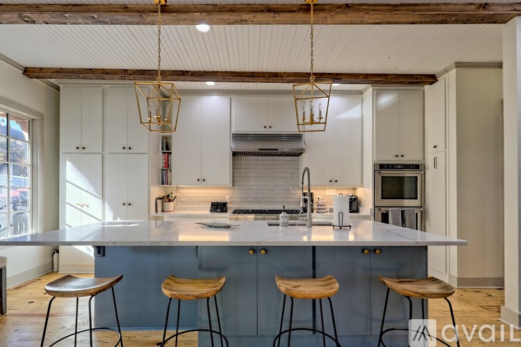 A kitchen with a bar area and stools.