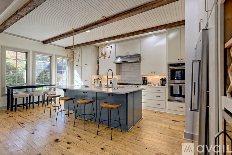 A kitchen with a bar area and a dining table.