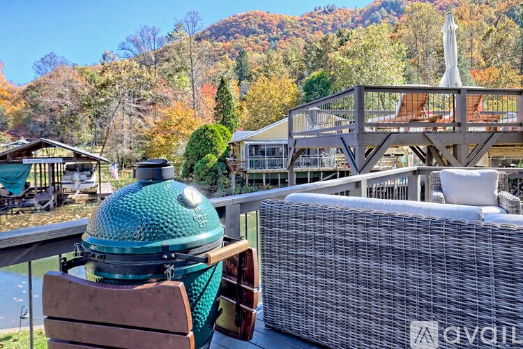 A patio with a hot tub and a mountain in the background.