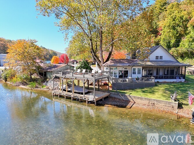 A house with a deck overlooking a body of water.