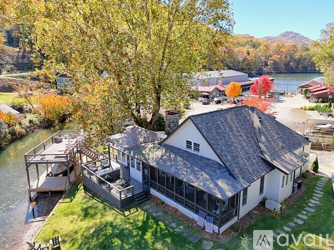 A house with a deck overlooking a river.