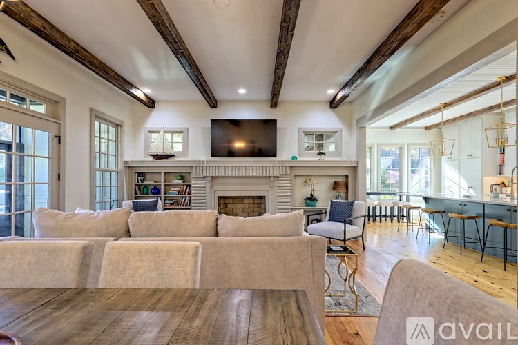 A spacious living room with a fireplace and a television.