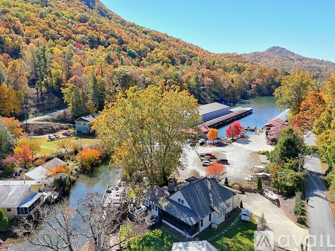 A beautiful autumn scene with a lake and houses.