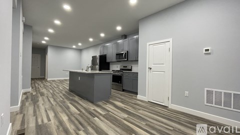 A kitchen area with a counter and cabinets.