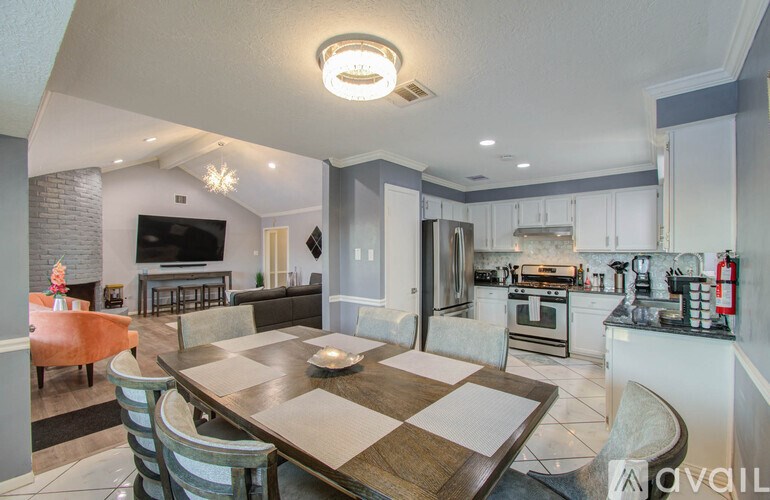 A modern kitchen with a dining table and chairs.