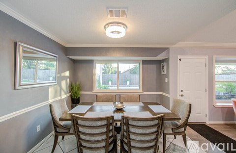 A dining room with a table set for six.