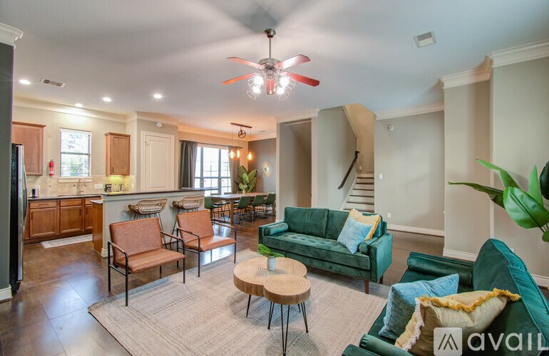A living room with a green couch and a fan.