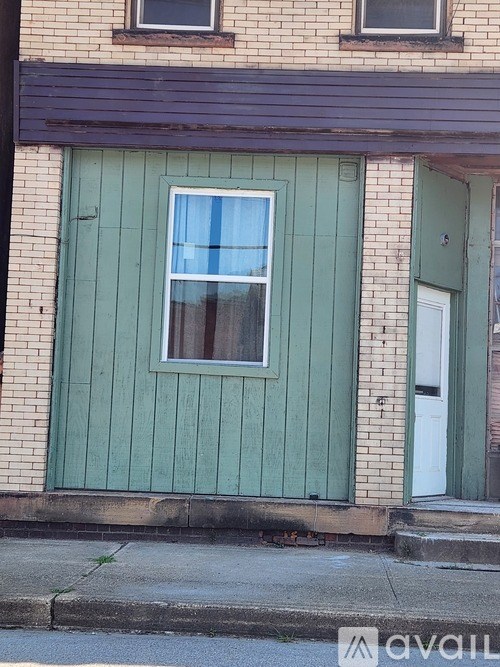A house with a green door and a white door.