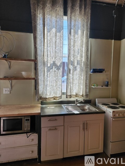 A kitchen with a microwave, sink, and oven.