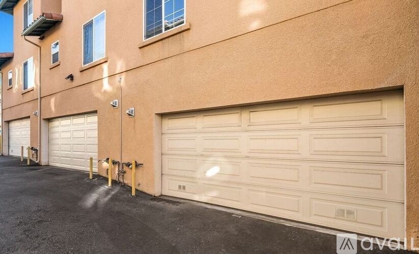 A row of garage doors in front of a building.