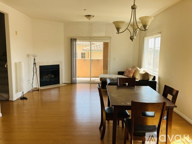 A living room with a fireplace and sliding glass doors.
