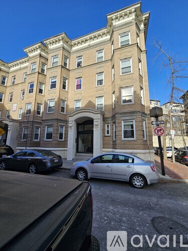 A tall building with a no parking sign in front of it.