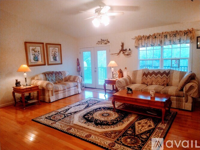 A living room with a rug and a couch.
