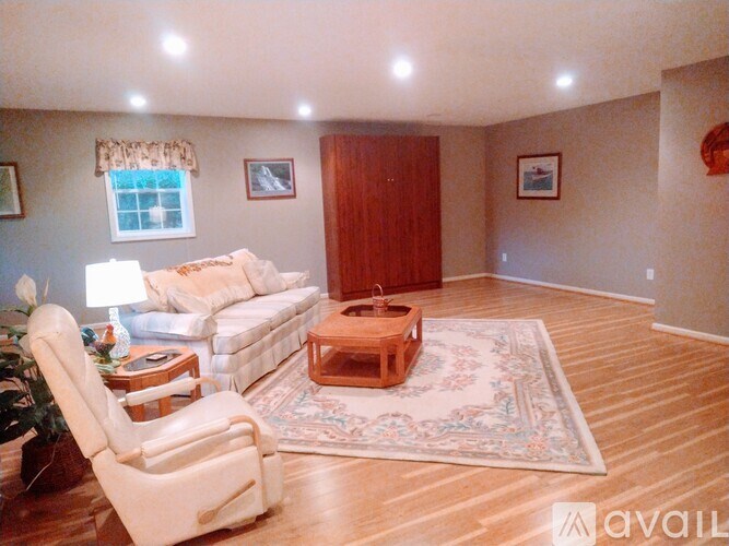 A living room with a white sofa and a wooden coffee table.