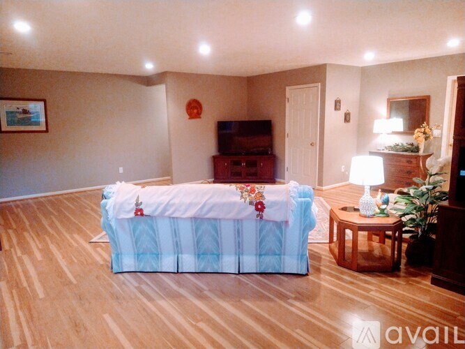A bedroom with a bed covered in a blue and white striped comforter.