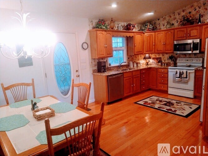 A kitchen with wooden floors and furniture.