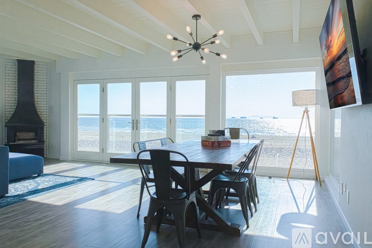 A dining room with a view of the ocean.