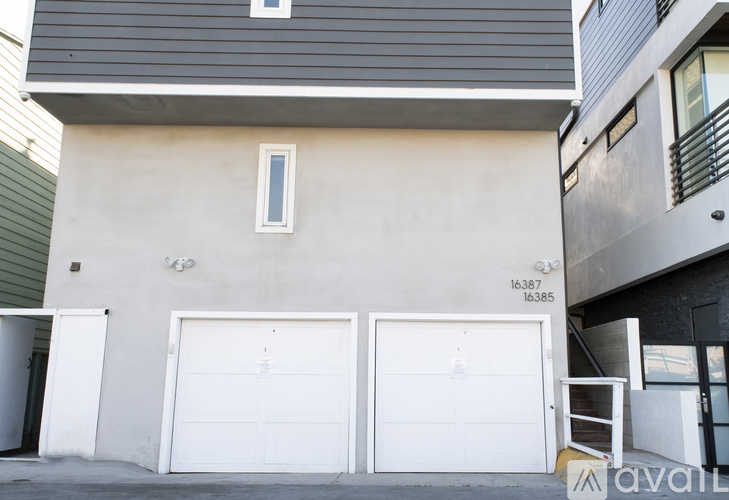 A two-story building with a garage door on the bottom floor.