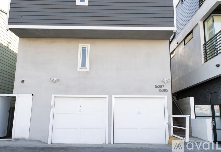 A two-story building with a garage door on the bottom floor.