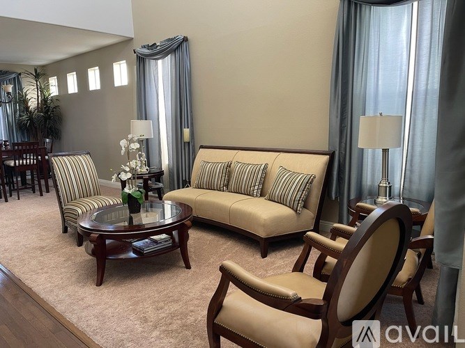 A living room with a sofa, armchair, and coffee table.