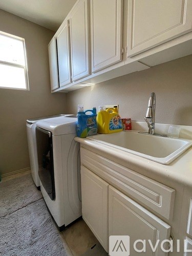 A kitchen with a white sink and a white dishwasher.