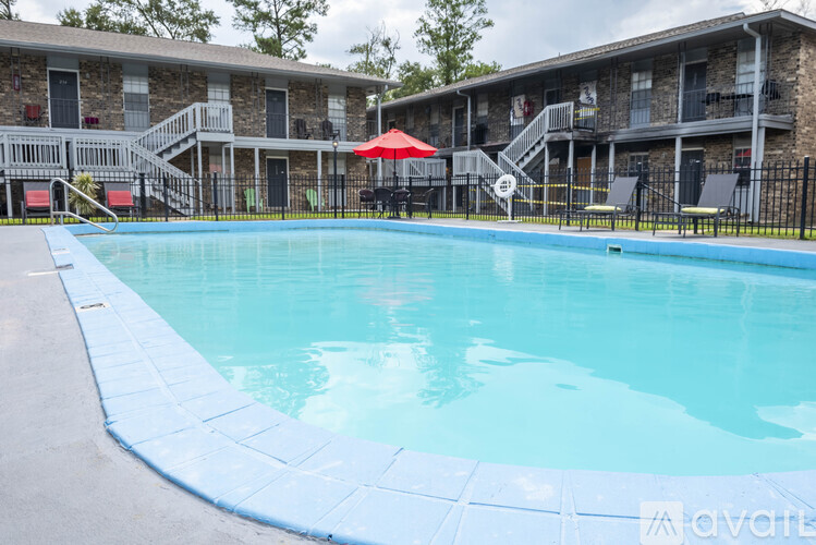 A swimming pool in front of apartment buildings.