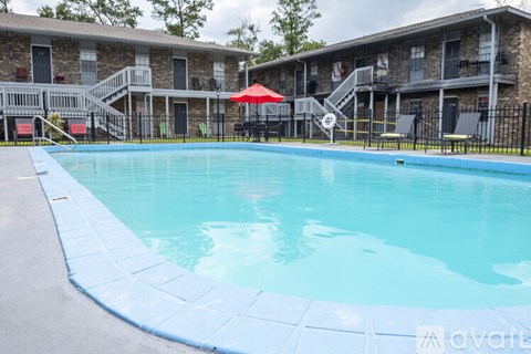 A swimming pool in front of apartment buildings.