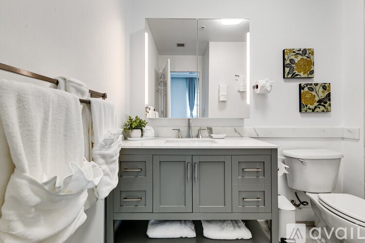 A bathroom with a white towel hanging on a rack.