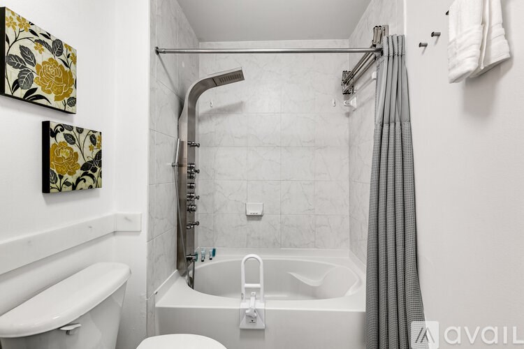 A bathroom with a tub, toilet, and sink.