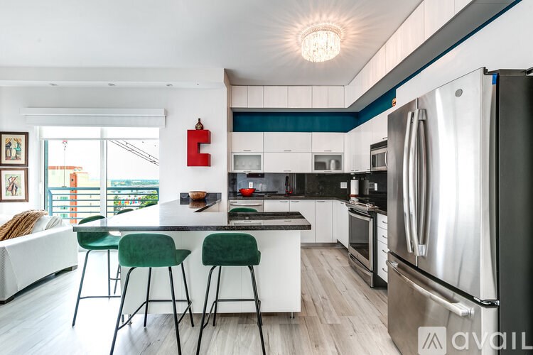 A modern kitchen with a large island and stainless steel appliances.
