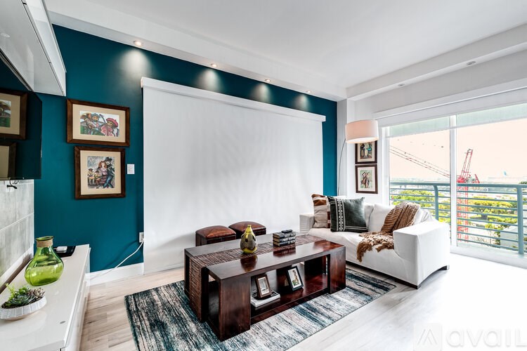 A living room with a white couch and a wooden coffee table.