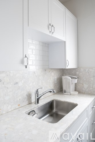 A kitchen with a sink and a toaster.