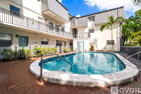 A small pool in a courtyard surrounded by buildings.